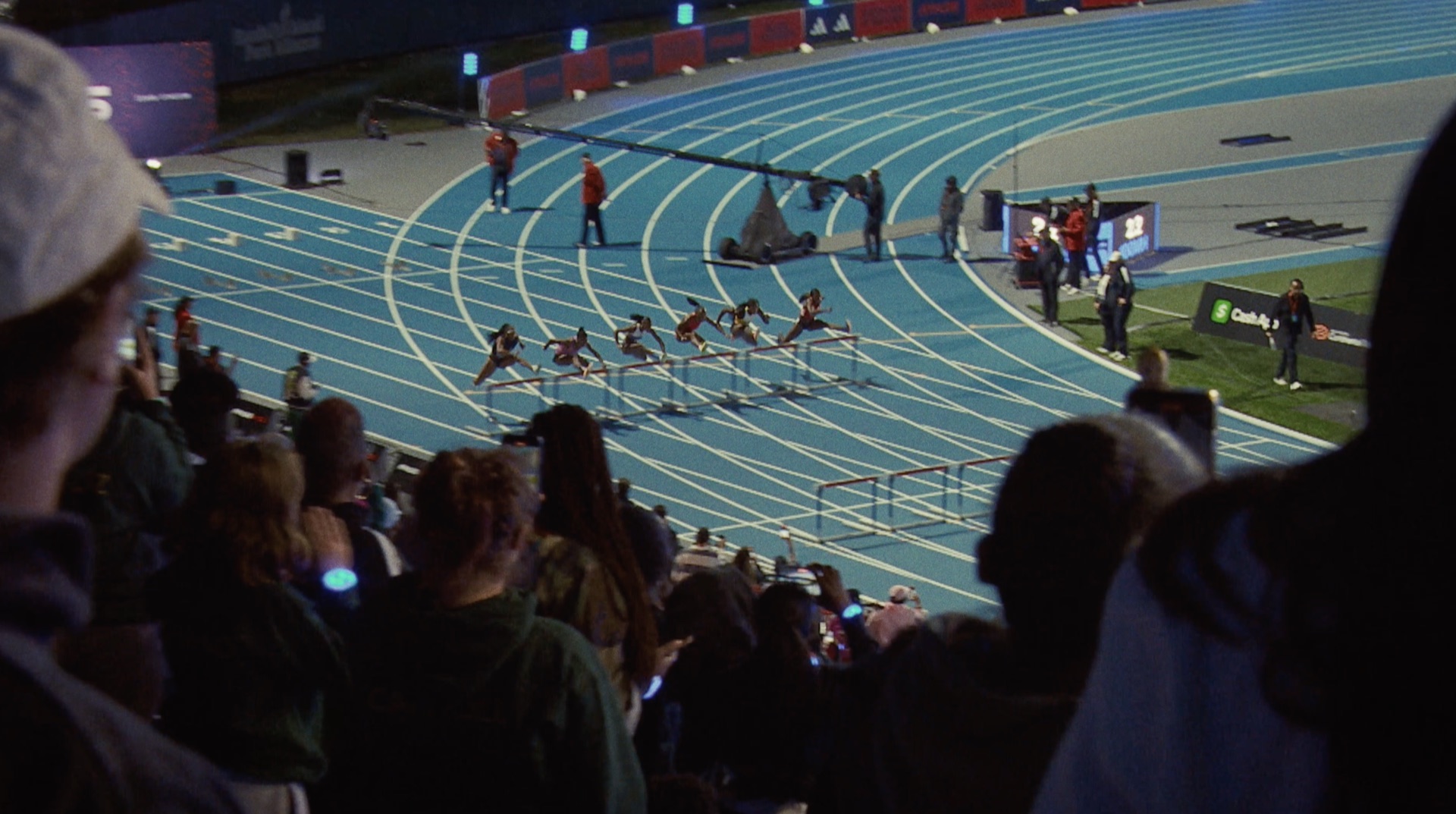 ATHLOS wordmark title card over an empty stadium track
