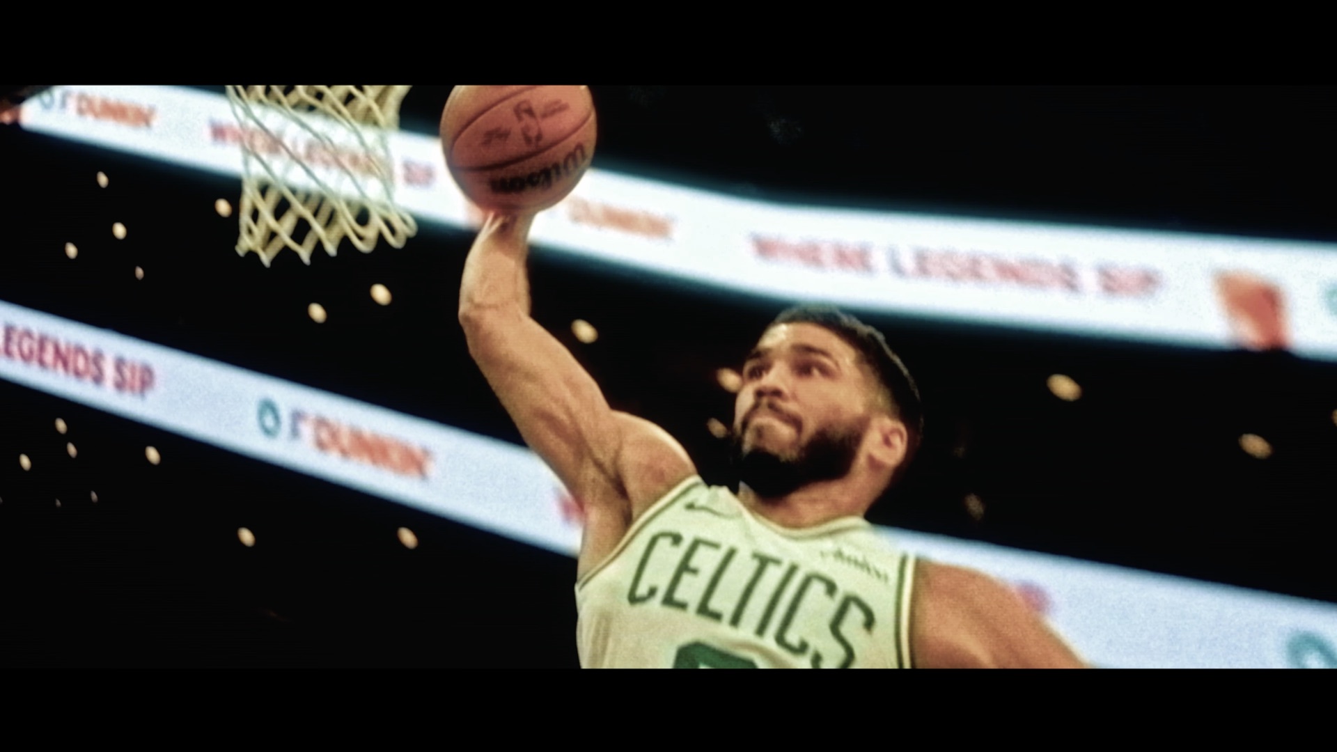 Celtics player dunking, close on the net