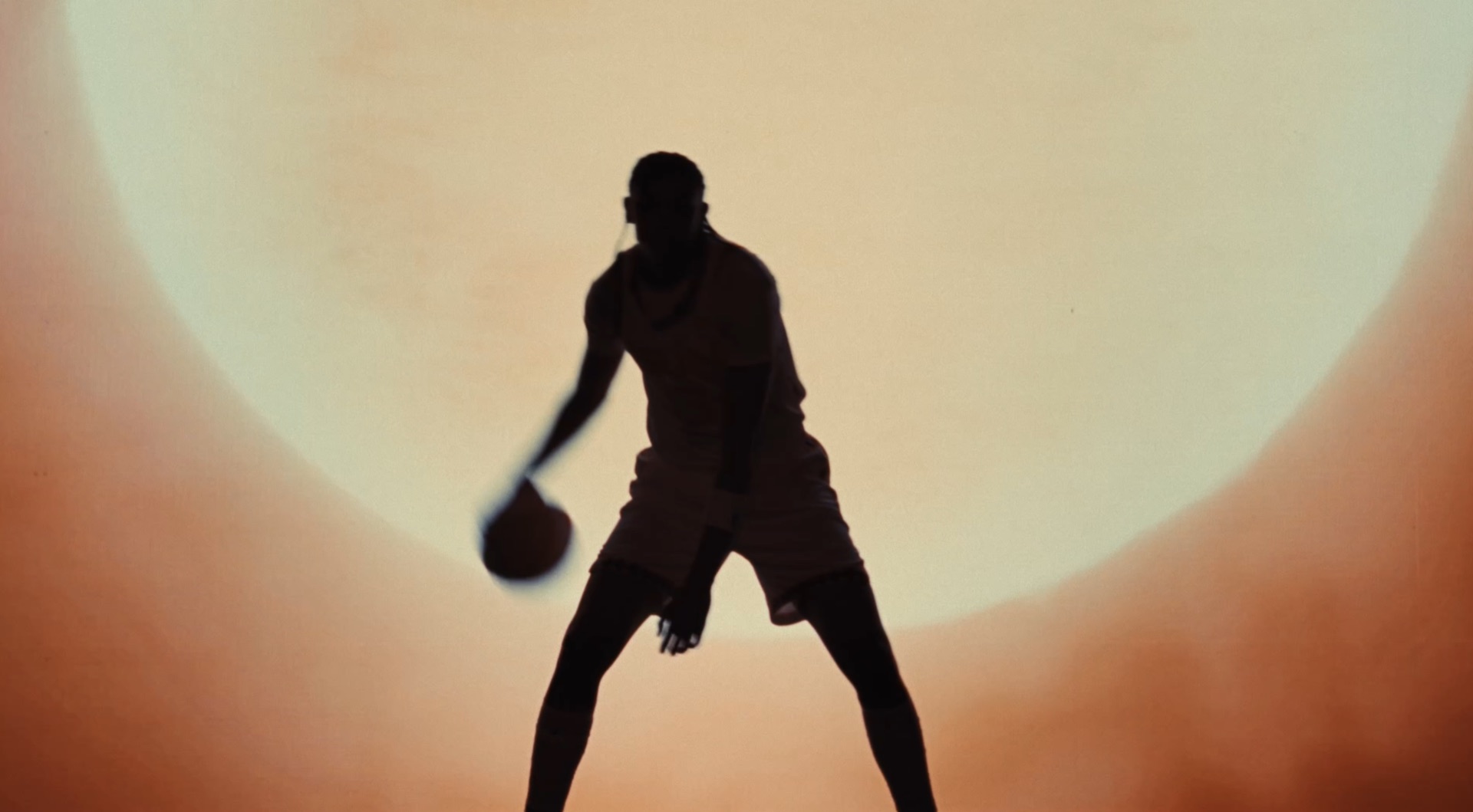 Game action: a player in a Connecticut jersey rising for a layup under the basket