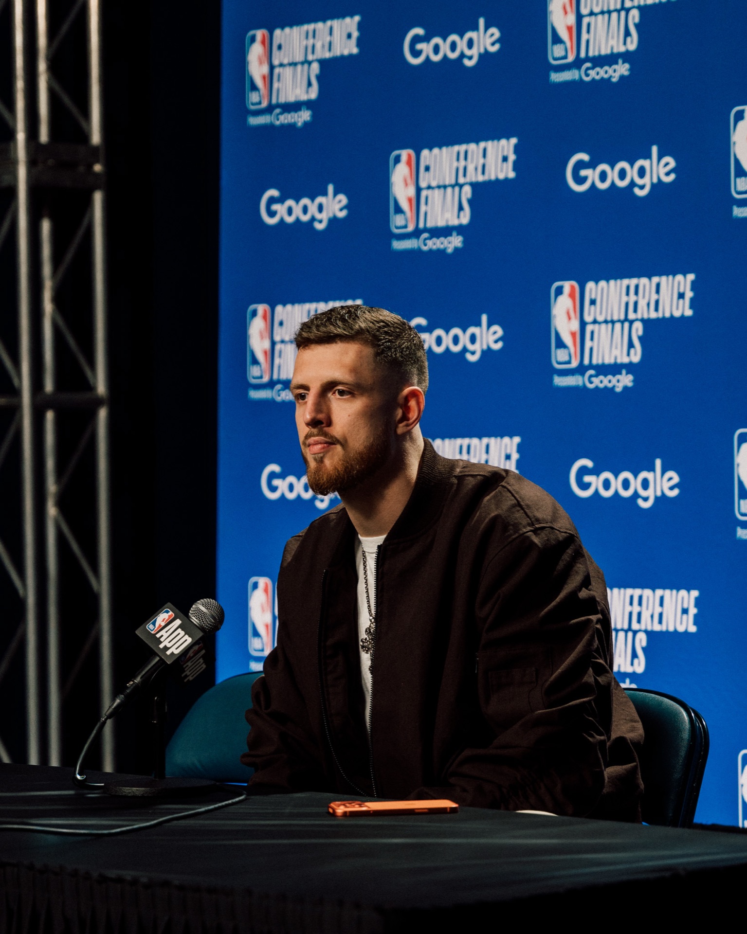 Isaiah Hartenstein seated at a Conference Finals press conference podium