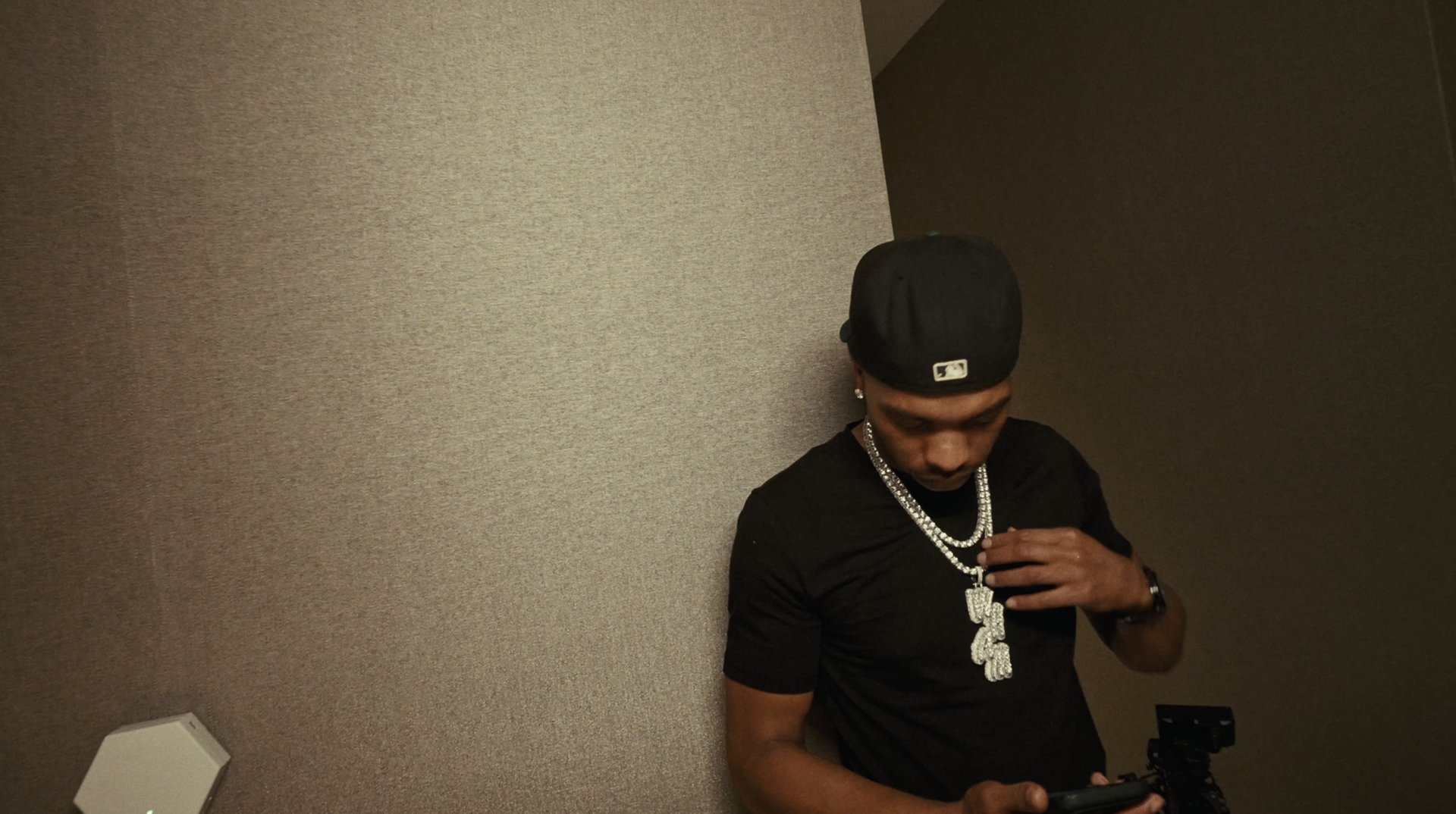Lil Baby adjusting his chain before the interview