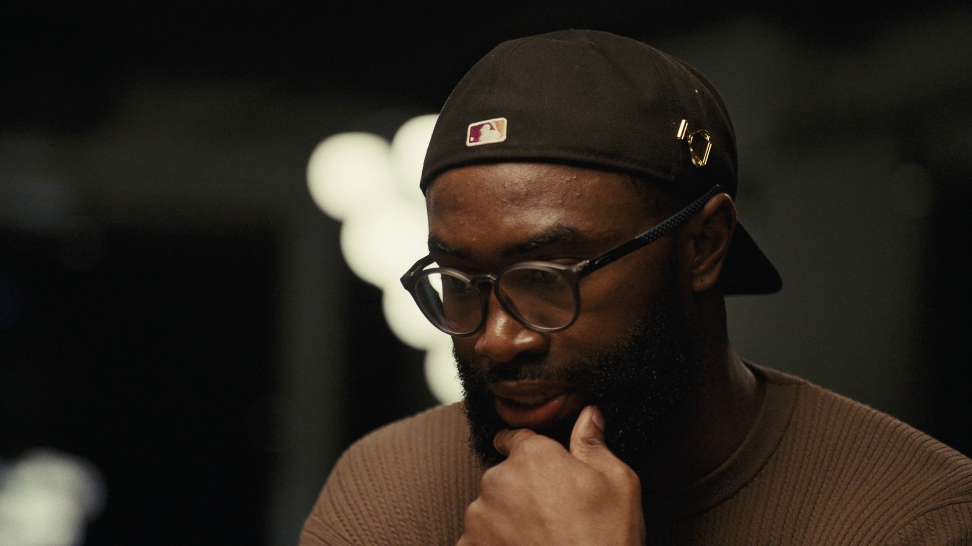 Jaylen Brown glancing down, hand to his chin