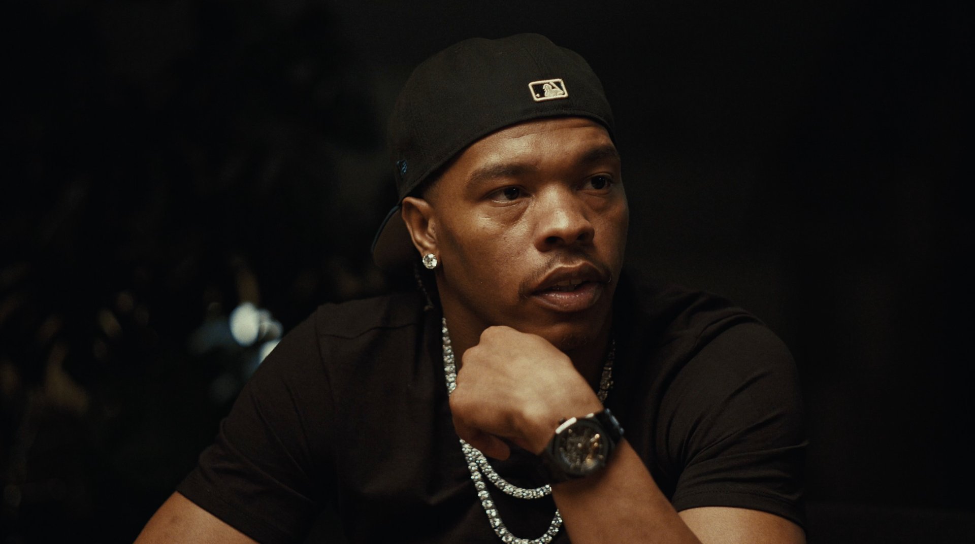 Lil Baby listening with his hand on his chin